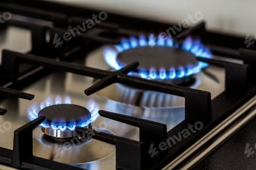 Preview: Natural gas burning on kitchen gas stove in the dark.