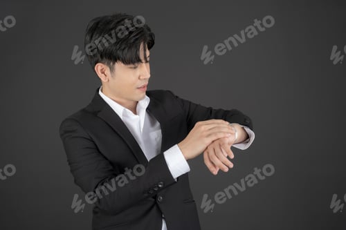 Preview: Business man wearing a black suit raising hands doing different gestures.