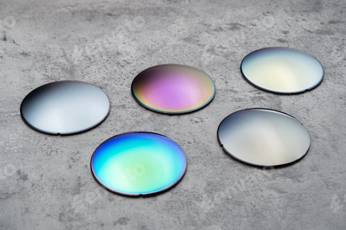 Preview: Different optical lenses on table in opical workshop