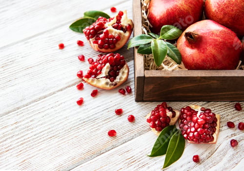 Pomegranates and Seeds on a Wooden Table