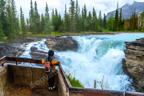 Preview: Tourist admiring athabasca falls in jasper national park, canada