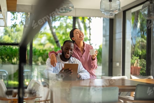 Preview: Online entertainment and social media. Diverse, multiethnic couple enjoying the digital world