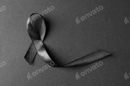 Preview: Black ribbon on dark background, top view with space for text. Funeral symbol