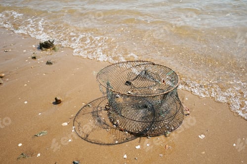 Preview: Old Crab Cage With Foam On Beach