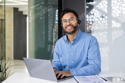 Preview: Smiling customer service representative using laptop in modern office environment