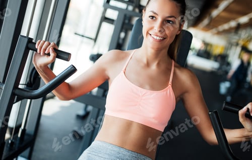 Preview: Beautiful young woman doing exercises for chest