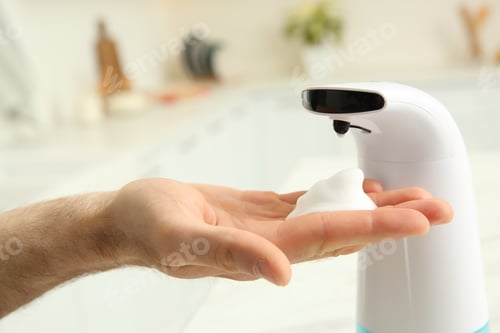 Preview: Man using automatic soap dispenser in kitchen, closeup