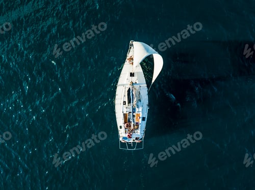 Preview: aerial photo of sailboat yacht top view, isolated on the sea texture. participant of sea regatta