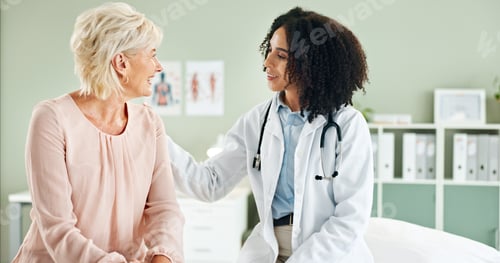 Preview: Senior woman, doctor and comfort in consultation with discussion, smile and good news at wellness c