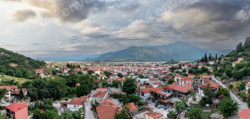 Preview: Kalambaka Greece. Sky with heavy clouds over Kalabaka town buildings and valley. Aerial view