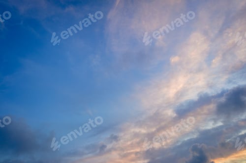 Preview: Autumn sunset sky background with warm colored clouds.