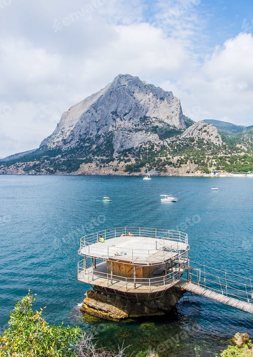Preview: Observation deck in the sea against the background of mountains