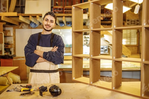 Preview: portrait of positive smiling carpenter at work place