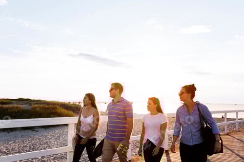 Preview: Friends walking on pier at sunset
