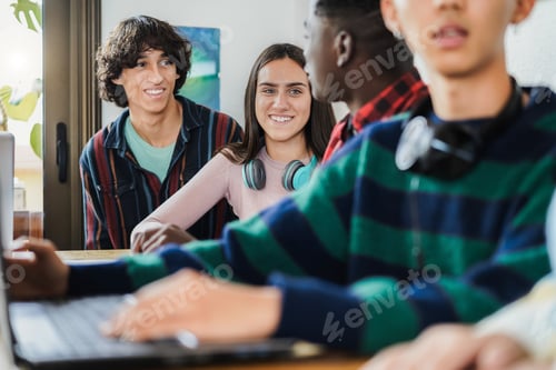 Preview: Multiracial students using laptop computers while studying together at school - Focus on girl face