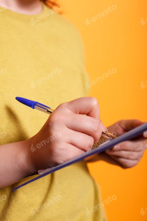 Preview: Female person writes on clipboard papers