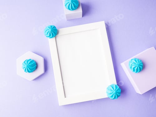 Preview: White empty frame on purple background with blue sweet decor, festive flat lay