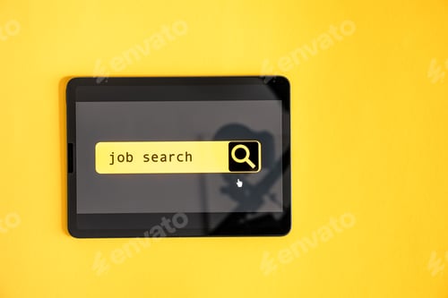 Preview: Top view of digital tablet with search job on screen on a yellow background.
