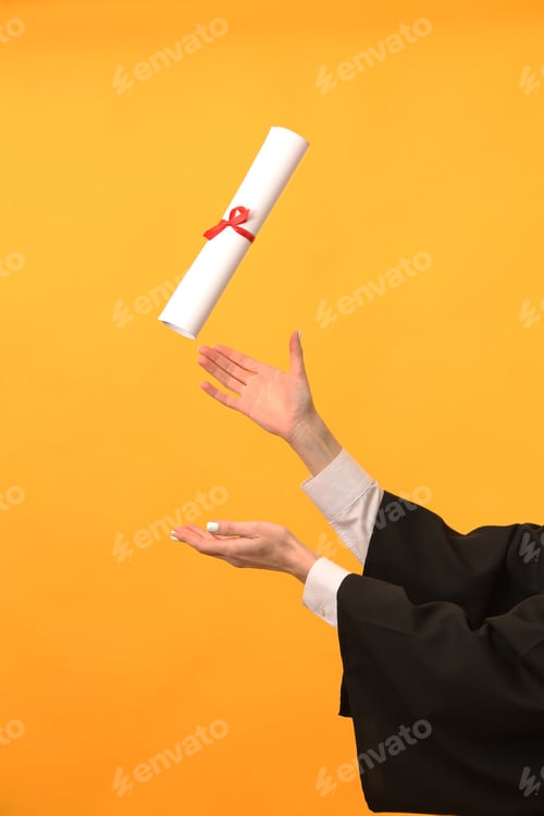 Preview: A happy graduate in cap and gown smiles and celebrates, the concept of education