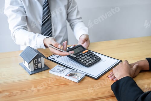 Preview: Estate agent are presenting home loan and giving house to client after signing agreement contract