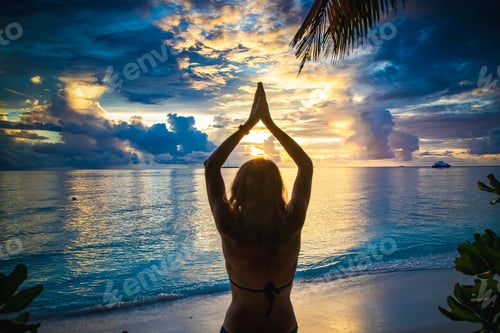Preview: woman doing yoga on exotic beach