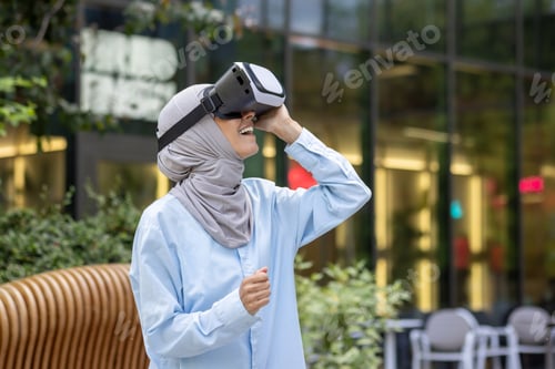 Preview: Muslim woman experiencing virtual reality outdoors