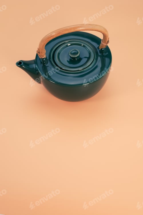 Preview: Vertical shot of a beautiful kettle on a coral background