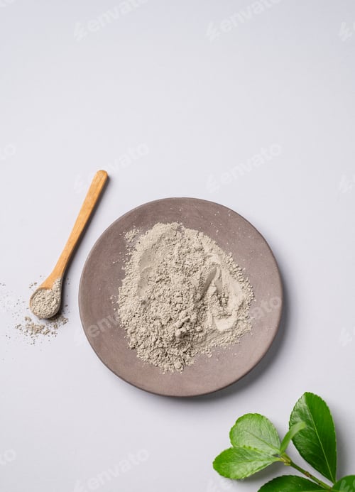 Preview: Dry blue clay on a light background. Concept for preparing homemade skincare organic cosmetics.