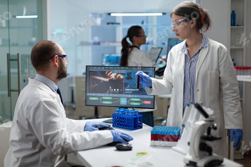 Preview: Medical team examining blood sample discussing virus expertise