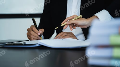 Preview: Businessman write project ideas and use pen to edit papers for brainstorming sessions with partners.