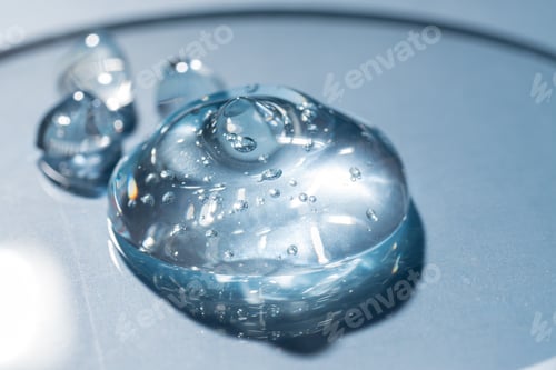 Preview: Gel cosmetic serum drop on petri dish on blue background. Lab research and cosmetic testing.