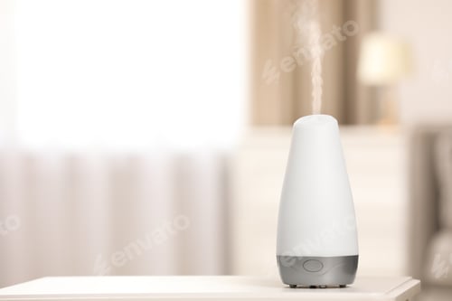 Preview: Modern essential oil diffuser on table indoors. Space for text