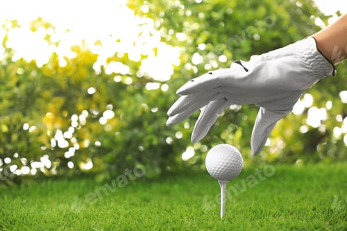 Preview: Player putting golf ball on tee at green course, closeup