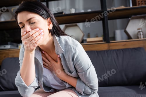Preview: woman with nausea and closed eyes covering mouth