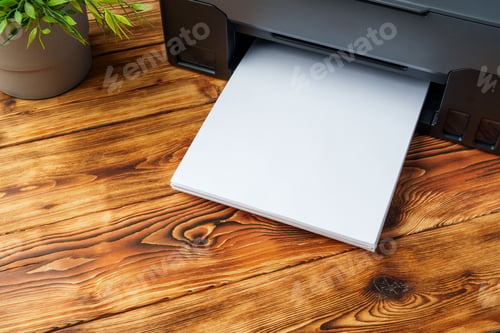 Preview: Modern laser printer with paper on wooden background