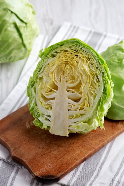Preview: Raw Organic Cabbage on a Rustic Wooden Board, side view.