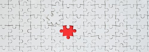 Preview: The texture of a white jigsaw puzzle in an assembled state with one missing element forming
