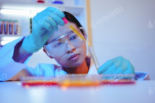 Preview: Asian female scientist passionately conducts experiments in a laboratory