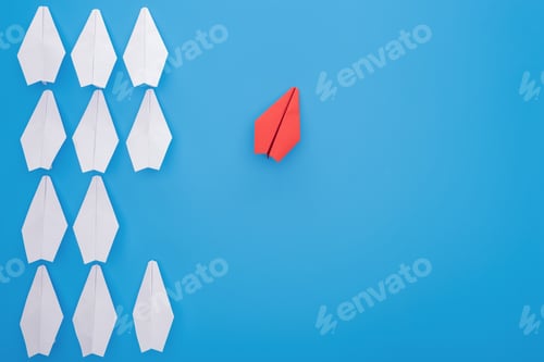 Preview: Flat lay with white and red paper planes on blue