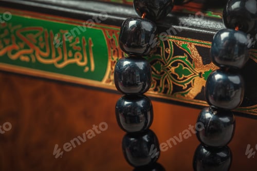 Preview: Muslim prayer beads on wooden background close up