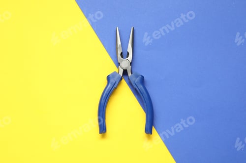 Preview: Needle nose pliers on color background, top view