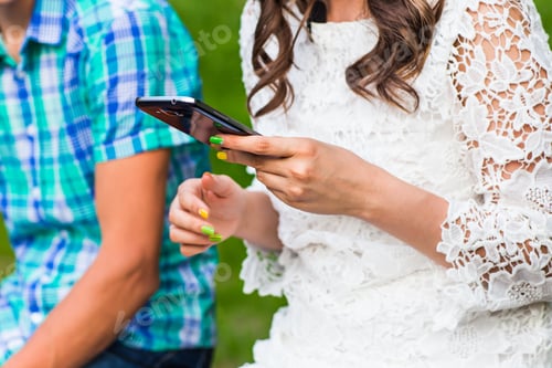 Preview: Couple looking at their smart-phones