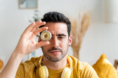 Preview: Man covering his eye with a compass.