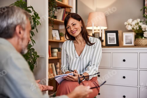 Preview: A dedicated female psychologist listens to a male patient during a session.