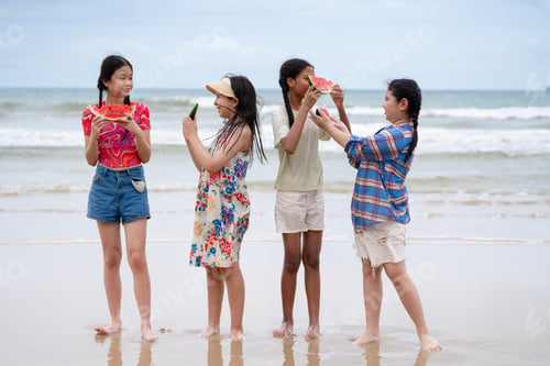 Preview: Happy children laughing and enjoying at beach. Kids playing with friends at the sea.