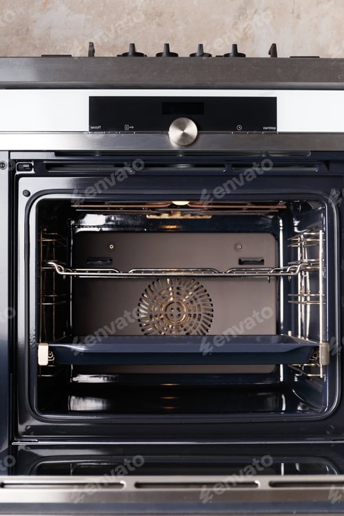 Preview: Built-in electric oven with open door in the kitchen.