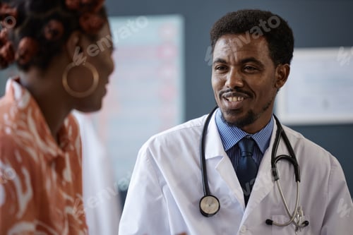 Preview: Closeup Black Doctor Smiling Listening to Black Woman in Consultation