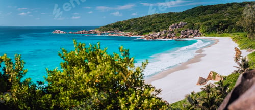 Preview: Panorama of epic Grand Anse Beach in La Digue island, Seychelles. White sand beach, big ocean waves
