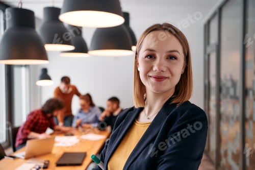 Preview: Confident Blonde Businesswoman Leading Team in Modern Office Setting.