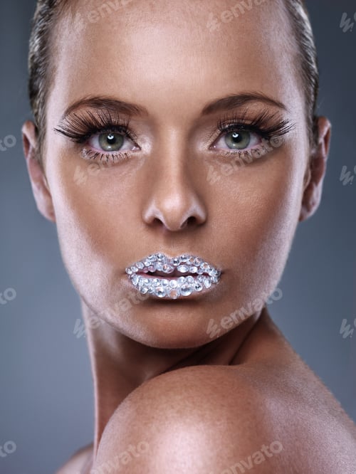 Preview: Million dollar kisses. Studio shot of a beautiful young woman with sparkling lips.